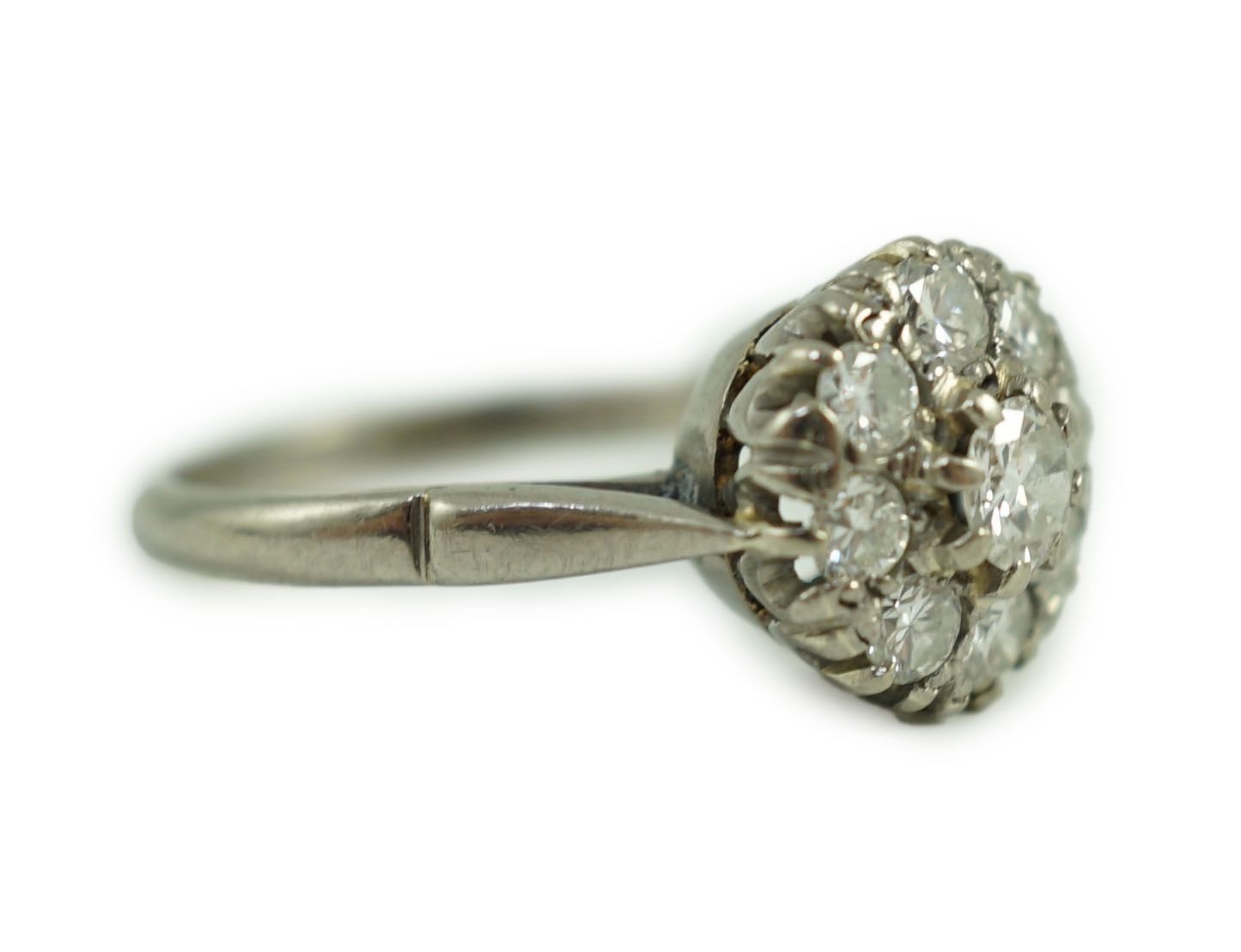 An 18ct white gold and nine stone diamond flower head cluster ring
